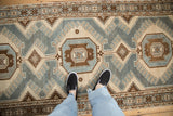 Personal view of the low-pile texture on a distressed Malayer runner's geometric blue and brown pattern.