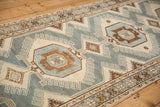 Low-pile weave of a vintage Malayer rug with finned details and starburst borders.