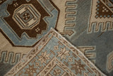 Corner view showing the hand-knotted foundation and low pile of a distressed vintage Malayer rug.