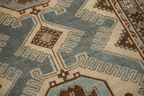 Close-up view of the distressed Malayer rug's finned detailing in slate blue and ivory.