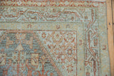 Distressed Serbend rug's meandering boteh border with dusty teal and terracotta hues, showing even wear.