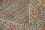 Antique Distressed Serbend rug corner detail, terracotta floral motifs on dusty teal, with mostly even pile wear.