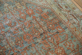 Distressed Serbend rug pile, dusty teal, terracotta floral elements, and visible foundation.
