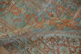 Storied texture and abrash of folded antique Serbend rug in dusty teal and terracotta.