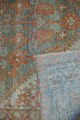 Antique Serbend rug close-up showing distressed terracotta and teal pile with visible foundation.