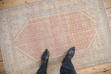 A standing perspective of the distressed boteh field on a vintage Persian Serbend rug.