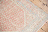 Machine-bound side and distressed, low-pile texture on a vintage Persian Serbend rug corner.