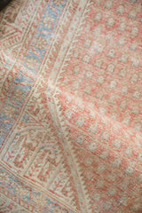 A soft fold reveals the worn texture and boteh pattern of a vintage Serbend rug.