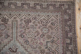 Distressed Qashqai rug runner corner; geometric border with faded fascia and slate blue gray.