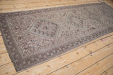 Vintage distressed Qashqai runner corner, faded chocolate geometric border, soft-toned field.