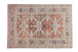 Vintage distressed Caucasian rug with three medallions in aubergine, terracotta, and faded blue.