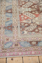Machine-bound edge alongside the geometric dragon-style border on a vintage Caucasian rug.