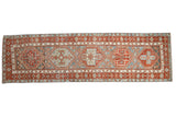Distressed Persian Karaja runner with geometric hexagonal medallions in brick red and sky blue.