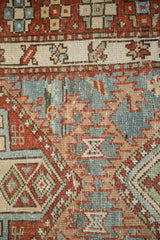Even wear to the knot heads and geometric bird motifs of a distressed Karaja runner.