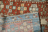 The low-pile geometric face and hand-knotted reverse weave of a vintage Persian Karaja rug.