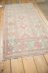 Angled view of a vintage Oushak runner highlighting its column of repeating medallions.