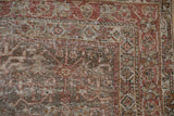 Distressed Persian Mahal rug corner, faded madder red motifs, and visible foundation.