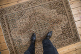 Distressed vintage Senneh rug with Herati pattern, heavy abrashes, powder blue, and dusty beige.