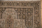 Vintage distressed Senneh rug with Herati pattern, stepped contour, muted dusty tones.