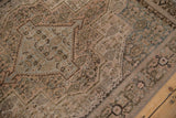 Distressed vintage Senneh rug with stepped contour, Herati motif, and powder blue abrashes.