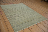 Distressed Senneh rug with repeating boteh pattern, worn powder blue pile.