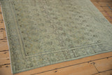 Distressed Persian Senneh rug texture with soft powder blue, silver, and gold boteh motifs.