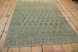 Vintage distressed Senneh rug displaying subtle boteh pattern and soft powder blue tones.