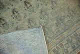 Distressed pale blue-green Senneh rug pile, revealing woven foundation and bound edge.