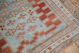 Distressed powder blue Caucasian rug with cherry red geometric stepped border and quatrefoil guls.