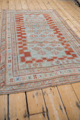 Distressed Antique Caucasian rug with powder blue field, brick red guls, and geometric stepped border.