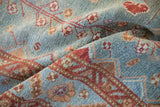 Distressed Malayer rug pile, showing nuanced floral motifs with powder blue and raspberry red abrashes.