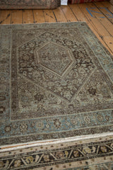 Distressed vintage Northwest Persian rug detail: hexagonal medallion, Herati design, charcoal and dusty blue.