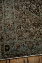 Distressed texture and faded charcoal field with dusty powder blue border on vintage Persian rug.