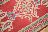 Vintage Oushak runner's cherry red field, ivory, and sky blue geometric patterns.