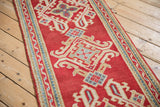 Intact side selvage of Vintage Oushak runner with cherry red field and patterned border.