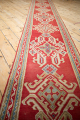 Vintage Oushak runner's cherry red field, ivory, sky blue ribboned vine border, quatrefoil motifs.