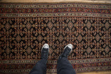 Intricate Herati field pattern and starburst floral border of a traditional Persian Hamadan runner.