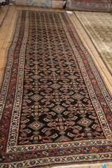 Angled perspective of the antique Hamadan runner, displaying its full length and geometric Herati design.