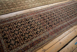 Angled perspective view of a traditional Persian Hamadan runner's dense allover Herati design.