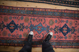 Vintage Mehriban runner with faded magenta, navy diamond medallions, palmette finials, and scattered plants.