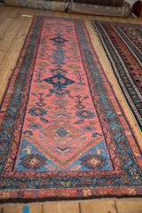 Dusty raspberry field of a vintage Persian Mehriban runner with navy diamond, serrated leaves, and detailed border.