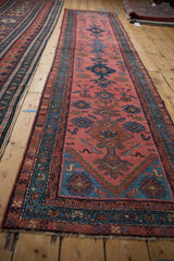 Vintage Mehriban runner with faded magenta field, blue border, germinating plants, and bird motifs.