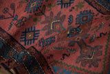 Faded raspberry and navy blue pile of the vintage Mehriban runner, with blooming wool tips.