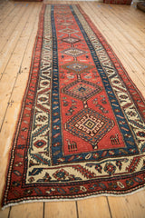 Angled perspective of an antique Persian runner with a column of geometric medallions.