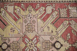 Detail of the starburst eagle style Kazak design with worn, even pile texture.