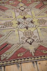 Detail of an antique Kazak rug's weave, showing the starburst motif and abrashed ground.
