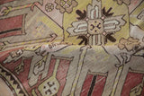Folded view of an antique Kazak rug showing the time-softened patina and hand-knotted texture.