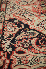 Close-up of antique Karabagh rug pile: intricate Rococo leaves and paisley botehs in navy, ivory, tomato red.