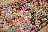Hand-knotted antique Karabagh: rococo leaves and paisley botehs in navy, ivory, and brick red.