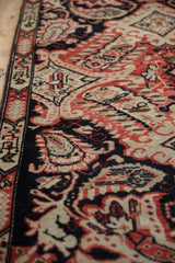 Antique Karabagh rug detail: Rococo-influenced blossoms, paisley botehs in navy, red, and aged ivory.